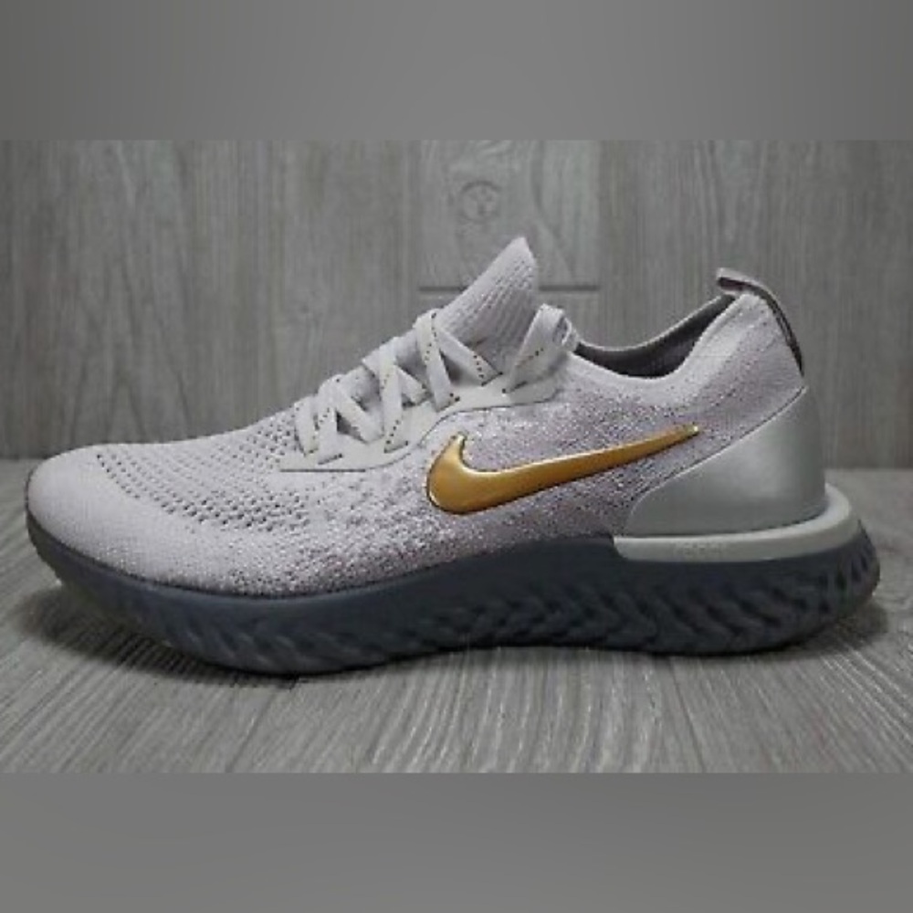 Nike Women’s Flyknit Running Sneakers in Light Gray with Gold Swoosh
